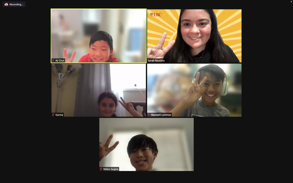Virtual Zoom meeting with students posing with the "Fight On!" sign