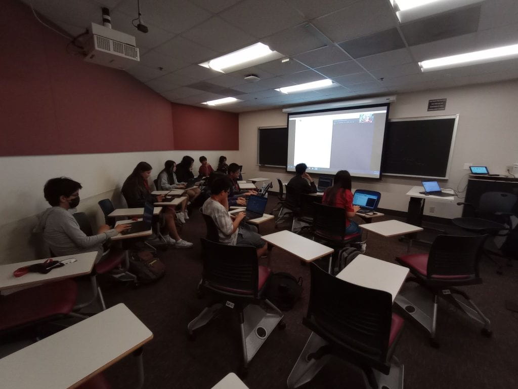 Students listening to a coding session inside an USC classroom